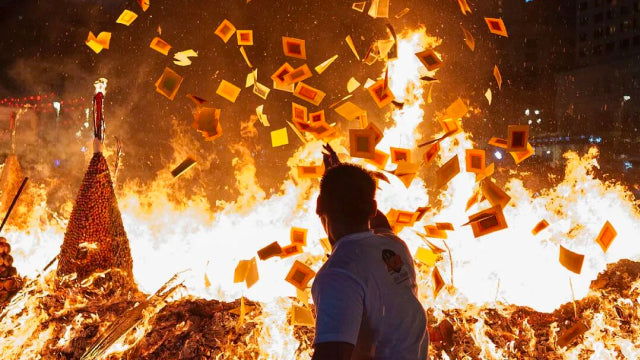 Burning paper offerings during China’s Ghost Festival Zhongyuan rituals, symbolizing respect for ancestors and spirits.