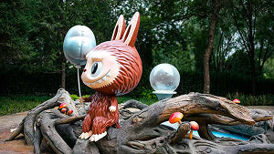 Cute Pop Mart bunny character statue with balloons at Beijing Pop Mart Theme Park 2025.