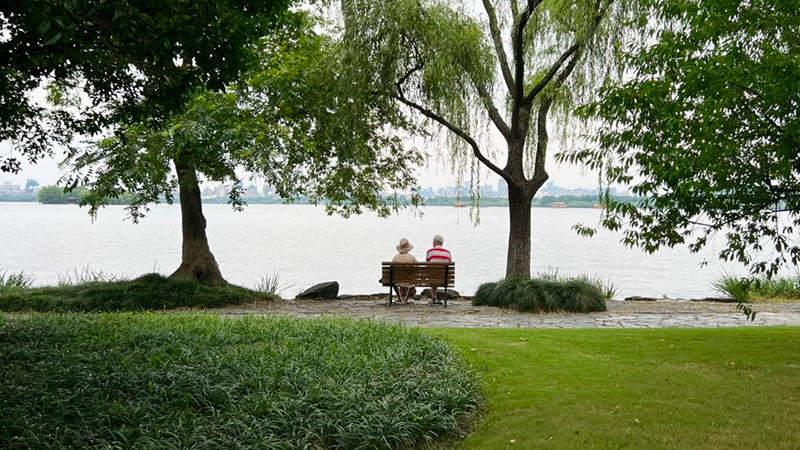 A couple sitting by the West Lake