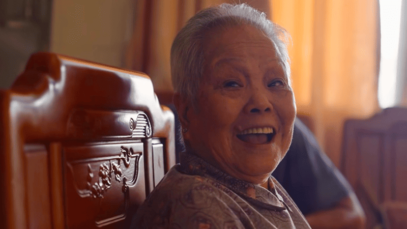 A smiling Self-Combed Woman grandmother facing the camera.