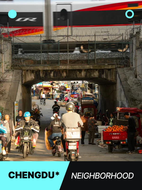Fast train crossing above a bustling Chengdu underpass filled with scooters, vendors, and vibrant street market activity