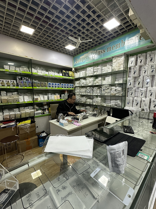 Electronics shop counter stacked with phone cases and accessories in Shenzhen Huaqiangbei market