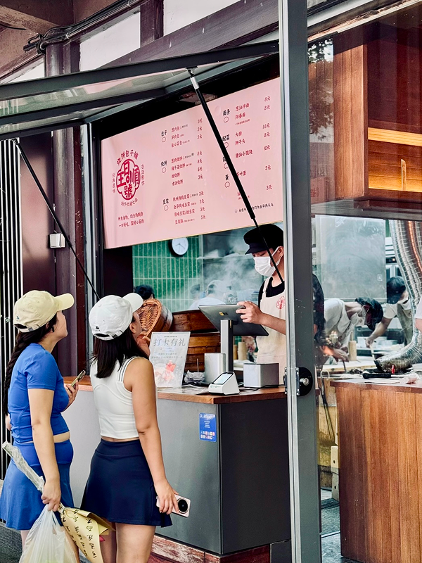 Small local breakfast shop in Hangzhou city center with customers lining up in the morning