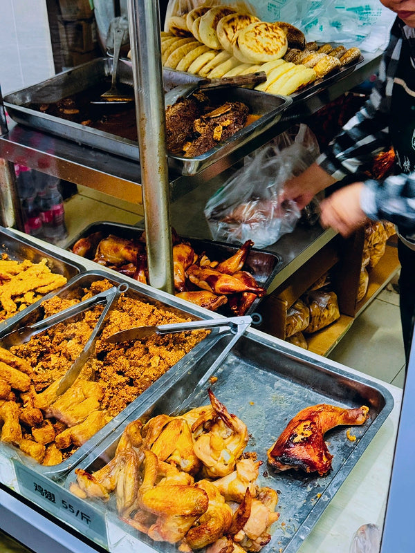 Authentic halal street food stall in Niujie with roast chicken, fried treats, and traditional Muslim-style pastries