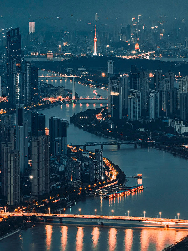 Stunning night panorama of Wuhan’s skyline with glowing bridges and the Yangtze River winding through the cityscape