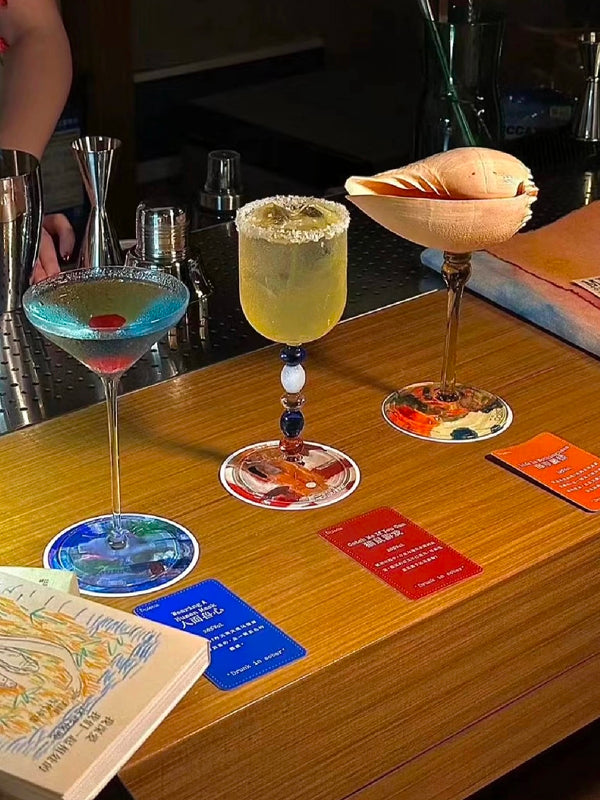 Signature cocktails with artistic glassware and curated coasters at a hidden mixology bar in Chengdu nightlife scene