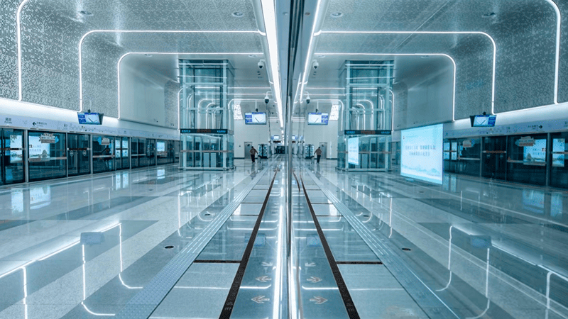 In China's subway, light and shadow take on a sci‑fi, futuristic quality, where the symmetry of the lights and platforms becomes a metaphor for rationality.