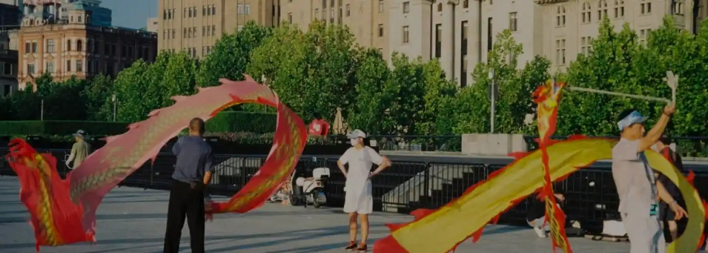 Locals practicing traditional dragon ribbon dance in a public square, uncovering authentic culture in modern China.