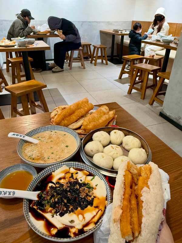 Local diners enjoying breakfast inside a simple Hangzhou neighborhood eatery