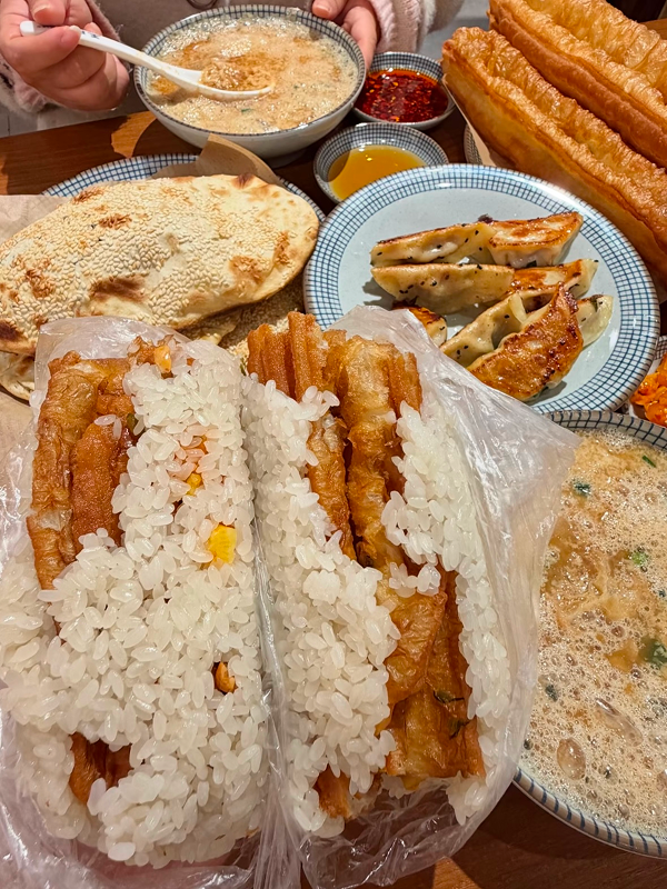 Sticky rice roll with youtiao and tofu pudding as part of a classic Hangzhou breakfast