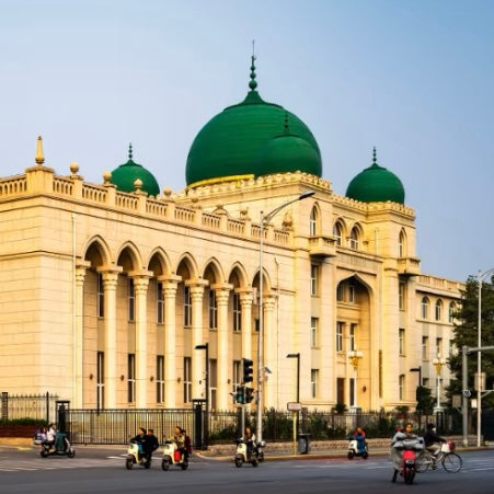 Grand Niujie Mosque with vibrant green domes and arched windows at sunset in Beijing.