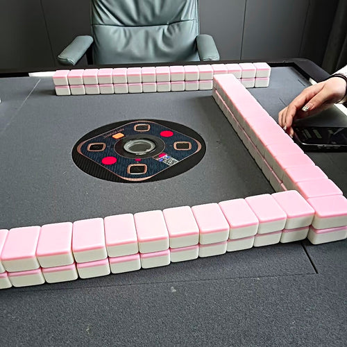 Automatic mahjong table with pink and white tiles neatly arranged before the game starts in Chengdu.