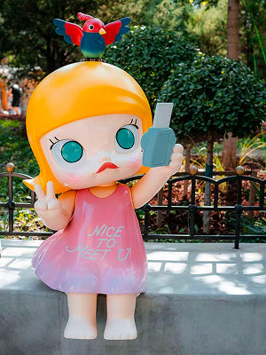 Pop Mart doll statue in pink dress with parrot on head at Beijing Pop Mart Theme Park.